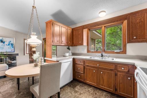 The kitchen offers abundant wood cabinetry, ample counter space, and a convenient eat-in area.