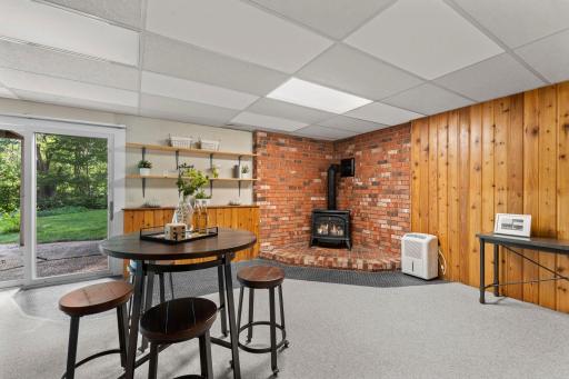 The family room is topped off with a cozy gas-burning stove with a brick surround and walkout access to the backyard patio.