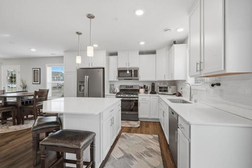 Upgraded soft-close white cabinetry paired with stylish slate appliances.