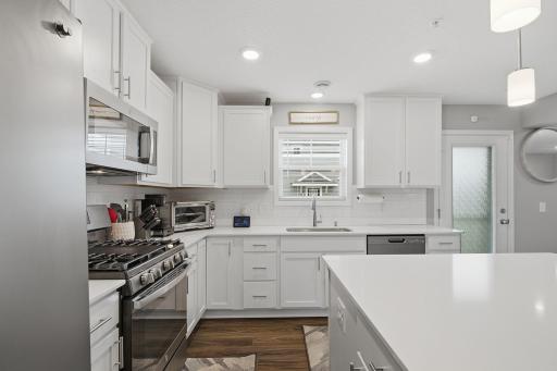 Modern kitchen with quartz countertops, center island and plenty of workspace.