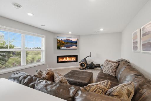 Spacious living room featuring great natural light and an electric fireplace.
