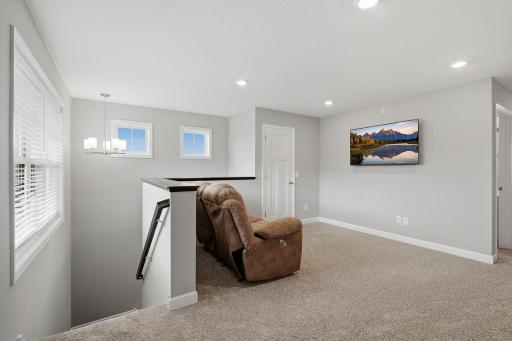 Spacious upper-level loft offers the perfect flex space for a home office, playroom or second TV area.