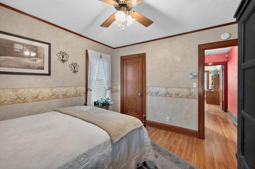 Natural light and a ceiling fan enhance the bedroomâs comfortable atmosphere.