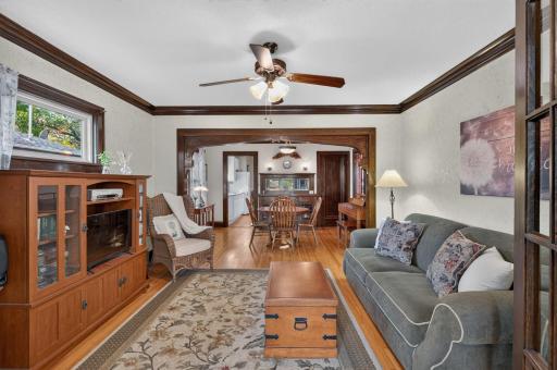 Beautiful hardwood floors and rich natural woodwork highlight the living roomâs timeless charm.