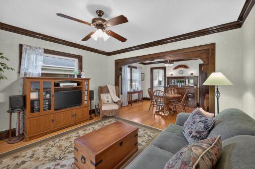 The living room offers a comfortable gathering space with access to the bright enclosed porch.