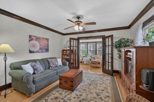 French doors connect the living room to the enclosed front porch.