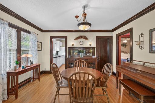 The formal dining room features hardwood floors and a beautiful built-in buffet with glass-front cabinetry.