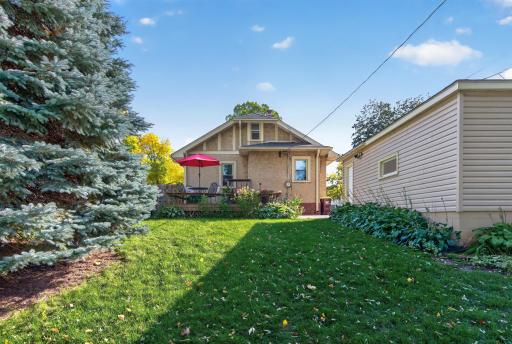 A rear view highlights the homeâs deck, backyard and mature landscaping.