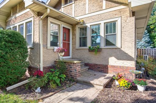 Brick entry steps, decorative architectural details and window boxes add character to the front entrance.