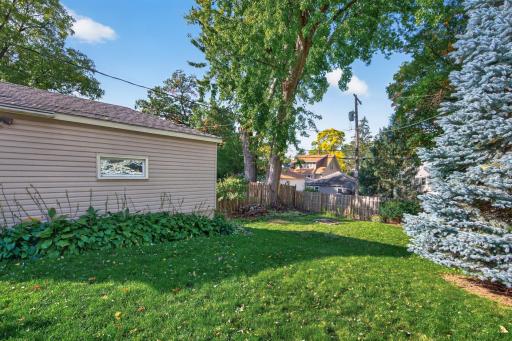 A detached garage sits alongside the backyard, with room nearby for gardening and outdoor enjoyment.