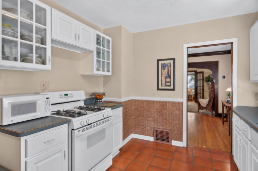 Glass-front upper cabinets add character and display space above the range.