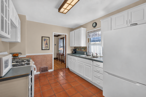 A window above the kitchen sink brings natural light into the workspace.