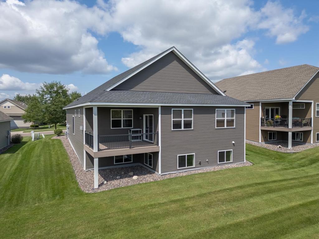 Maintenance free back deck is covered and offers great natural views of a pond.