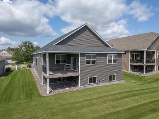 Maintenance free back deck is covered and offers great natural views of a pond.