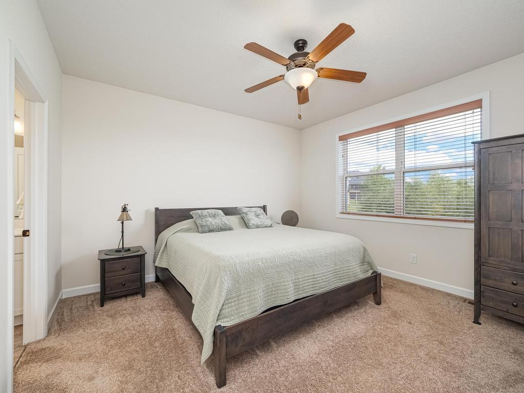 Main floor Owners Suite offers views of pondin backyard plus assures your privacy since no other homes can be built behind your home. Fan/light keeps you cool during summer months.