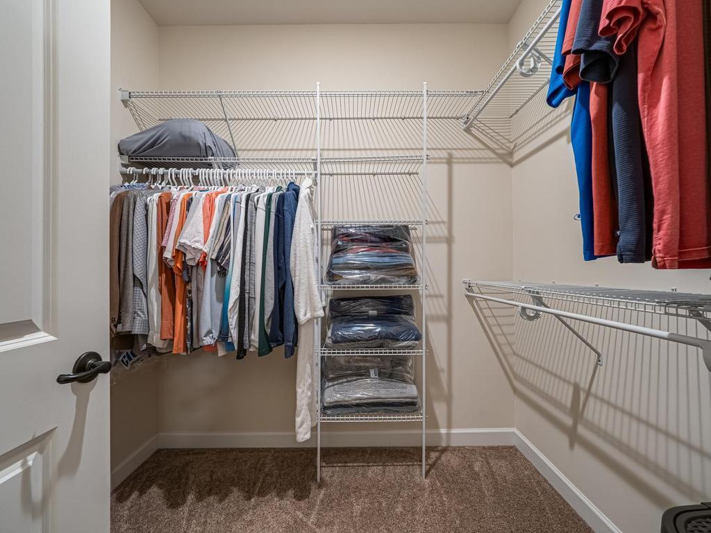 Owners suite walk-in closet keeps you organized.