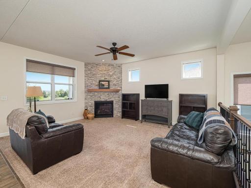 Spacious Great Room lets in plenty of natural light. The gas fireplace surrounded natural stone. Double window to left of fireplace overlooks back deck with beautiful views of the pond. Large ceiling fan keeps you cool during hot summer months.