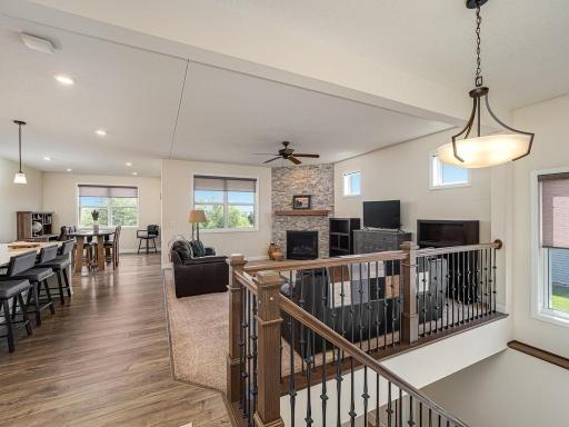 Open main floor layout. This classic staircase with wooden railing borders the Great Room.