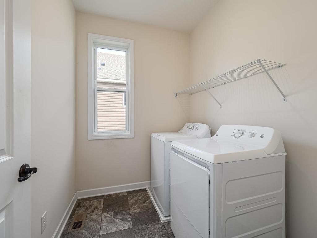 Main floor laundry conveniently located near kitchen and mudroom. Washer and dryer included.