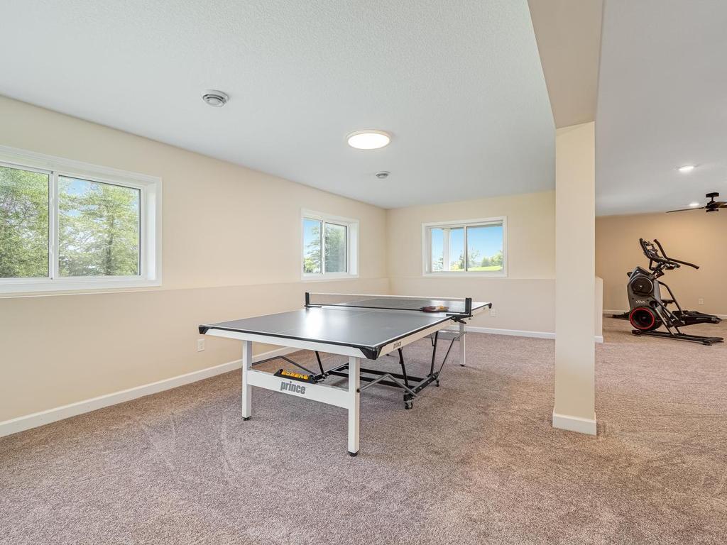 Amusement room features look-out windows which is great spot for a ping pong or pool table.