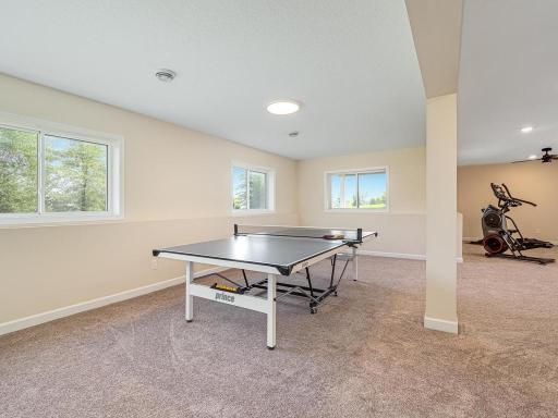 Amusement room features look-out windows which is great spot for a ping pong or pool table.