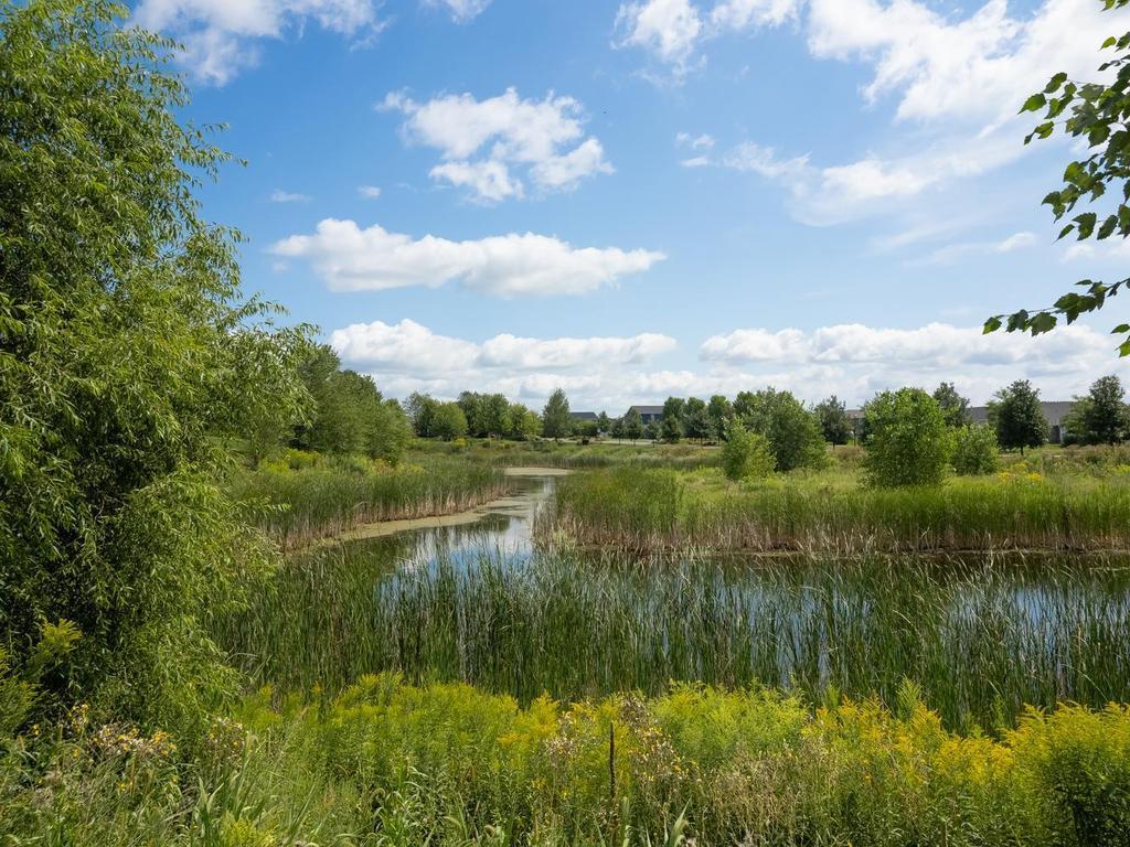 Natural pond adds a peaceful setting behind this home assuring no one can build another home directly behind you.