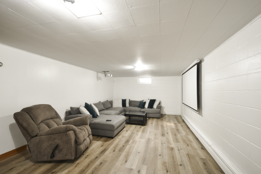 Lower level family room! Lots of space! The projector and the screen do not stay. LVP ran throughout the lower level.