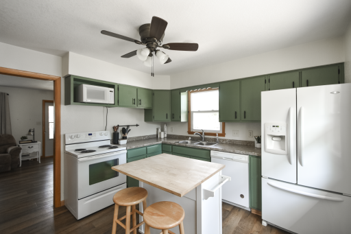 Updated kitchen cabinets with a fresh coat of paint, center island and a built in pantry all in the kitchen.