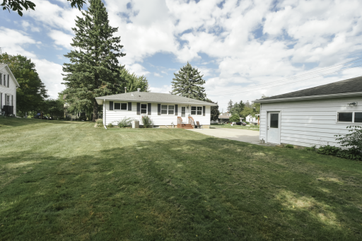 Rear view of the house. The steps bring you into the kitchen area. kitchen to the right, lower level stairs straight ahead and bedroom to the left.