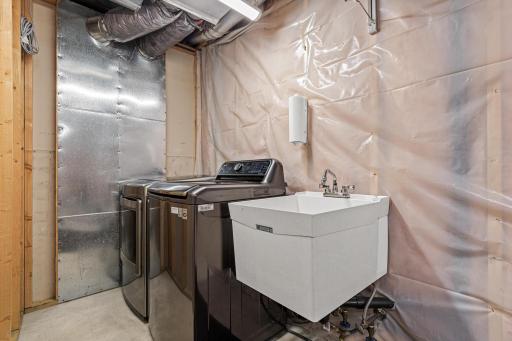 Spacious lower-level laundry room with plenty of room for everyday organization.