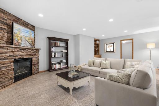 The family room is a destination year-round- watch the big game or your favorite movie. This room walks out to a private backyard. New carpet, paint and an updated fireplace surround give the lower level a fresh, inviting feel. Visually staged.