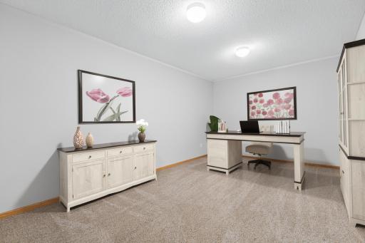 Lower-level den, exercise or craft room. In-floor heat, new carpet and paint. Visually staged as an office.