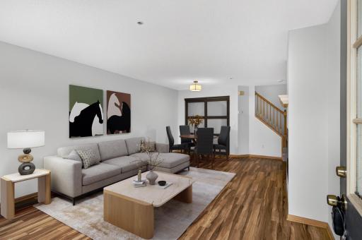 Sun-filled living & dining with plank flooring. Virtual staging.