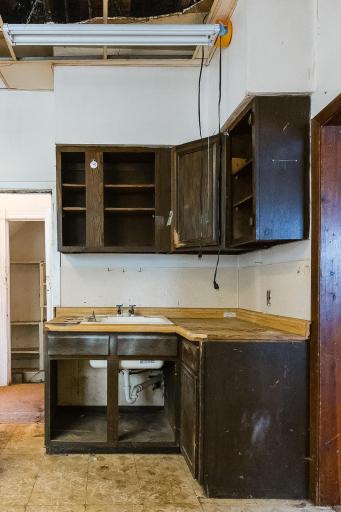 Main level kitchen sink with door to basement on the left of photo