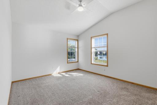 Upper level primary bedroom with north and east windows plus large walk-in closet.