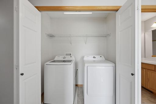 Convenient upper-level laundry keeps everyday chores close to all three bedrooms, with a dedicated closet and built-in shelving above the washer and dryer for added storage.