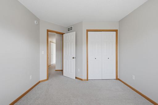 A second view highlights the bedroomâs generous closet space and flexible layout, with ample room to create a comfortable bedroom, guest space or home office.