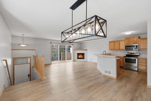 The open-concept design seamlessly connects the dining area with the kitchen and living room, creating an easy flow throughout the main level and a welcoming layout for gatherings.