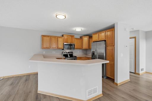 The kitchenâs breakfast bar peninsula provides additional prep space along with casual seating, while keeping the kitchen open and connected to the surrounding main-level living areas.