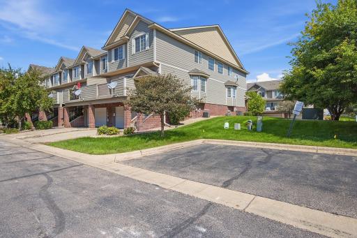 The end-unit location provides additional green space alongside the home, creating a more open feel than an interior unit. Convenient additional parking is located just steps away, making it easy to accommodate guests.