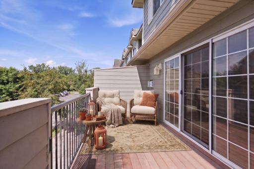 Enjoy an outdoor extension of the living space on the low-maintenance deck, offering plenty of room for outdoor seating, dining or grilling while overlooking the surrounding community. -Virtually Staged