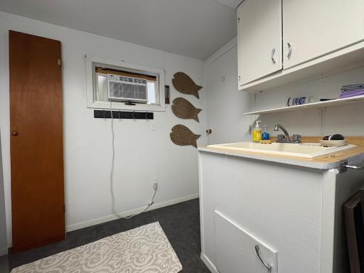 washer and utility sink in laundry room