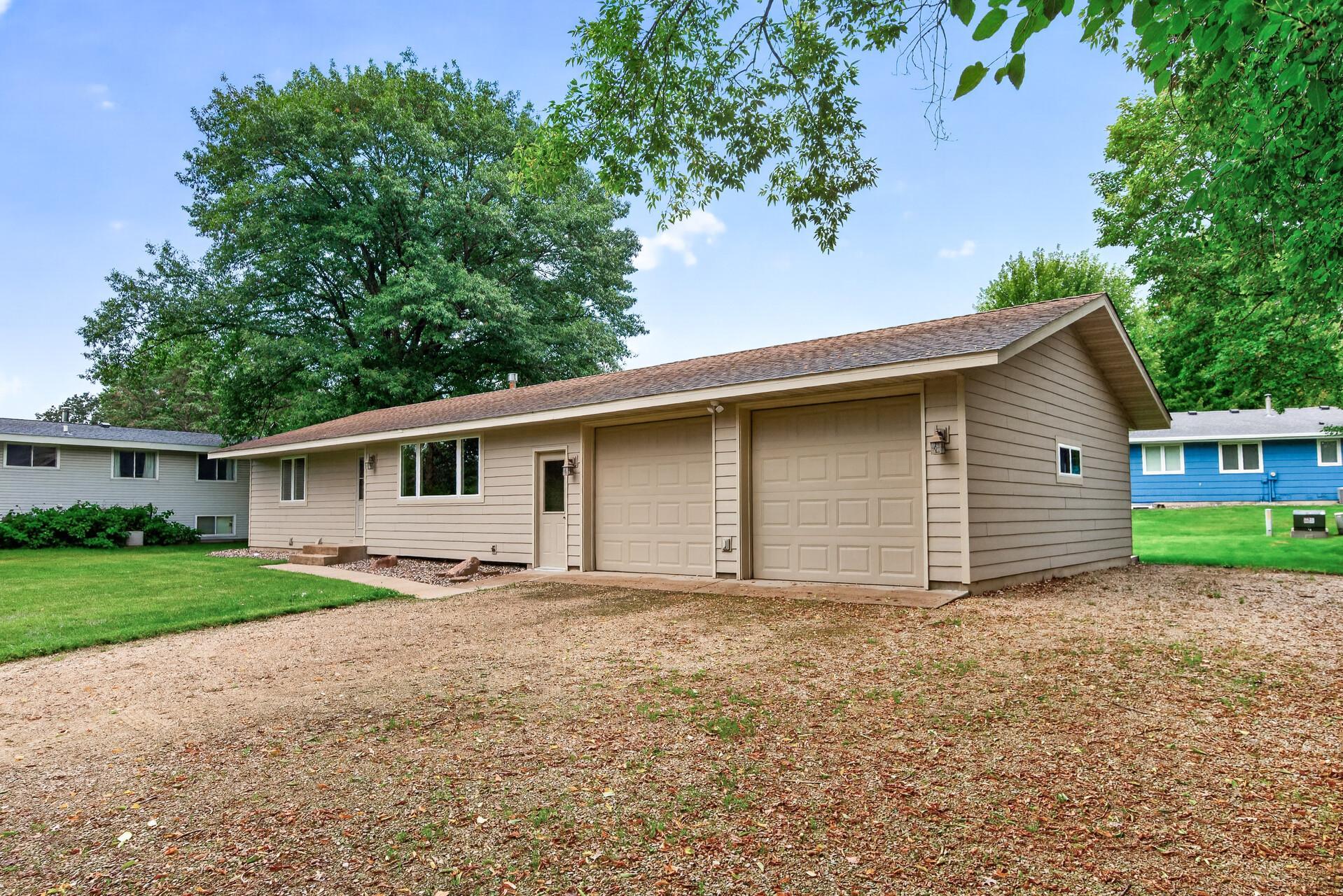 Spacious two car garage with additional parking alongside the garage.