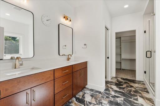 The primary en-suite with separate toilet room, walk-in shower, large soaking tub and expansive walk-in closet