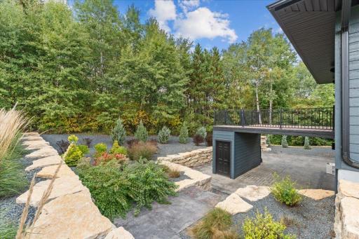 Stamped concrete patio and walkway from garage is a stunning outdoor living space
