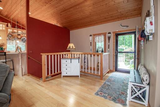 Enter this wonderful home through this spacious entryway! You will notice the ash hardwood floors and the vaulted wood ceilings throughout much of the main level!