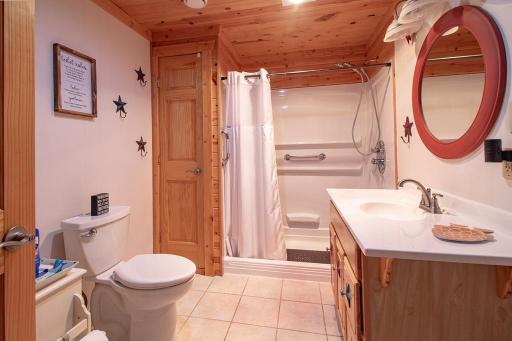 3/4 bath lower level features tub sized shower with easy access & grab bars.