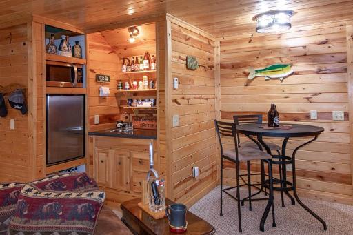 Area at back of family room features space for game table, wet bar, and bar fridge! Lower level is in floor heat too!