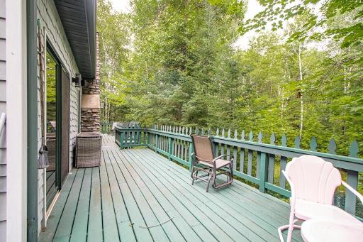 Deck off dining area looking towards primary bedroom. NOTE: this deck wraps around to side of dining area/kitchen!