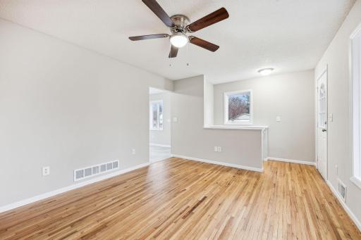 Spacious living room with gleaming hardwood floors